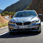 The Engaged Driver's Dream**
A dynamic, low-angle shot of a sleek BMW i5 (or 5 Series) carving through a winding mountain road under clear skies. The car's lines should emphasize its agility and power. Inside, a glimpse of the driver's hands gripping the steering wheel, with the intuitive Curved Display subtly visible, reinforcing the focus on a precise, driver-centric experience. The overall mood is one of exhilaration and control, highlighting the "Art de la Conduite" (Art of Driving).

**